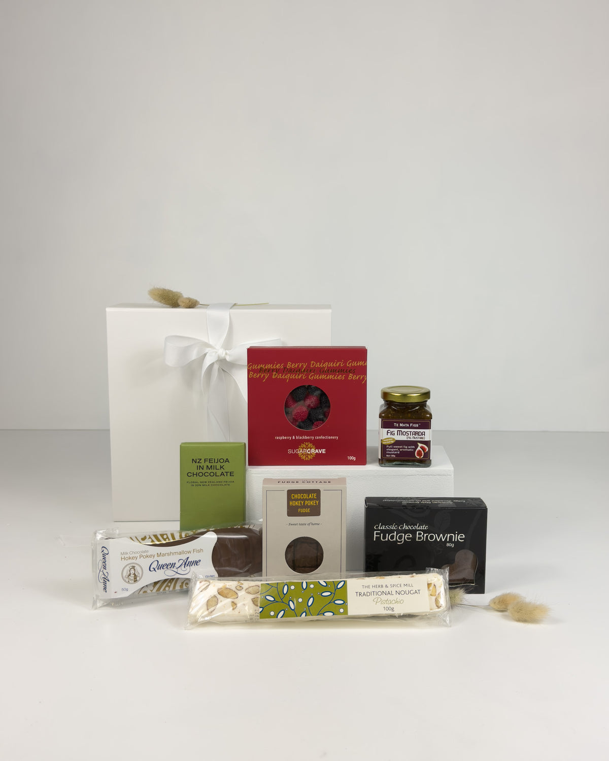 ALT text:
A Wee Surprise Gift Box filled with premium New Zealand chocolate, delicious fudge and artisan sweet treats, beautifully presented as a thoughtful gift to brighten someone’s day.