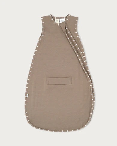 Baby wearing the Babu 3 Season Merino Sleeping Bag made from soft 100% extrafine merino wool for cosy and breathable sleep comfort.