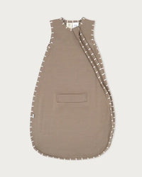Baby wearing the Babu 3 Season Merino Sleeping Bag made from soft 100% extrafine merino wool for cosy and breathable sleep comfort.