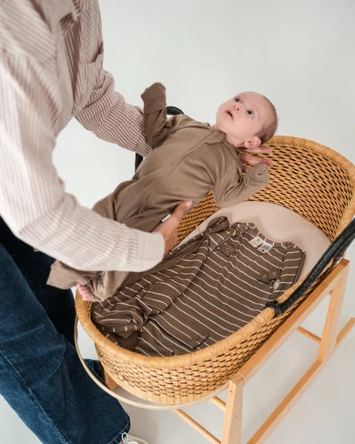 Baby wearing the Babu 3 Season Merino Sleeping Bag made from soft 100% extrafine merino wool for cosy and breathable sleep comfort.