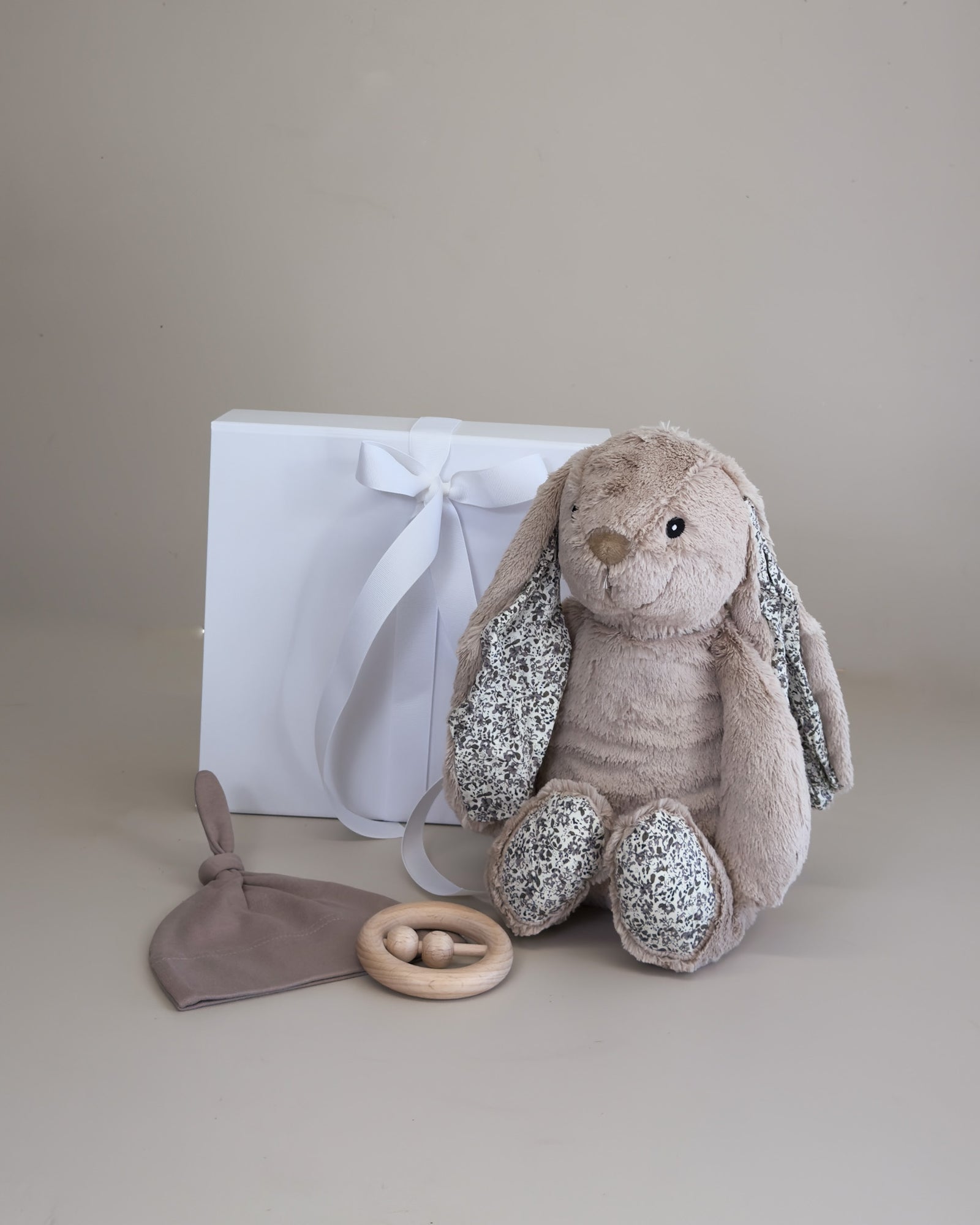 Newborn baby boy gift box with a fluffy bunny teething toy and soft beanie, beautifully arranged for a special baby gift.