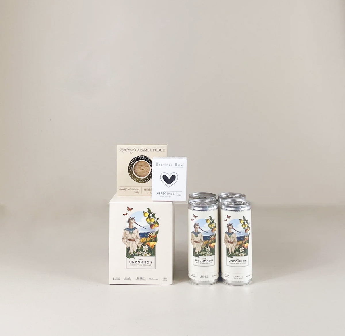 Cheers & Treats Gift Box with four cans of NZ wine, handmade fudge and brownie bite.
