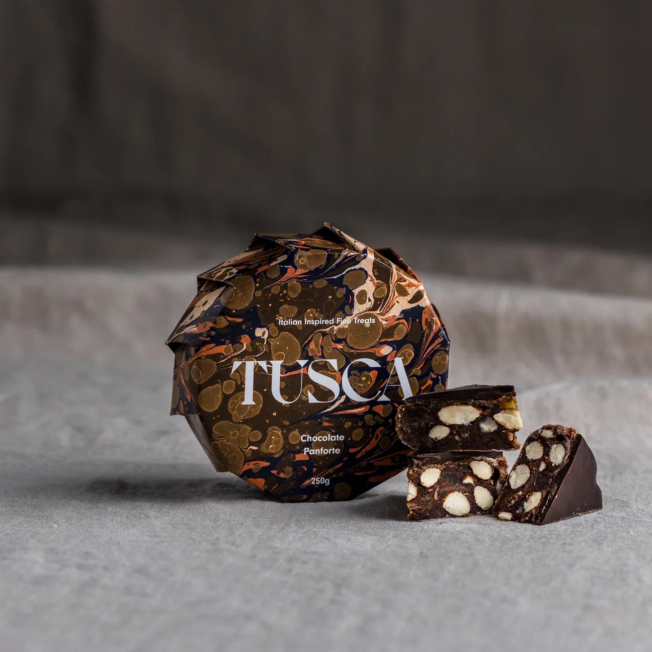 Dark chocolate panforte with citrus peel and glace cherries, a rich gourmet dessert-style treat ideal for celebrations and pairing with sweet wine.