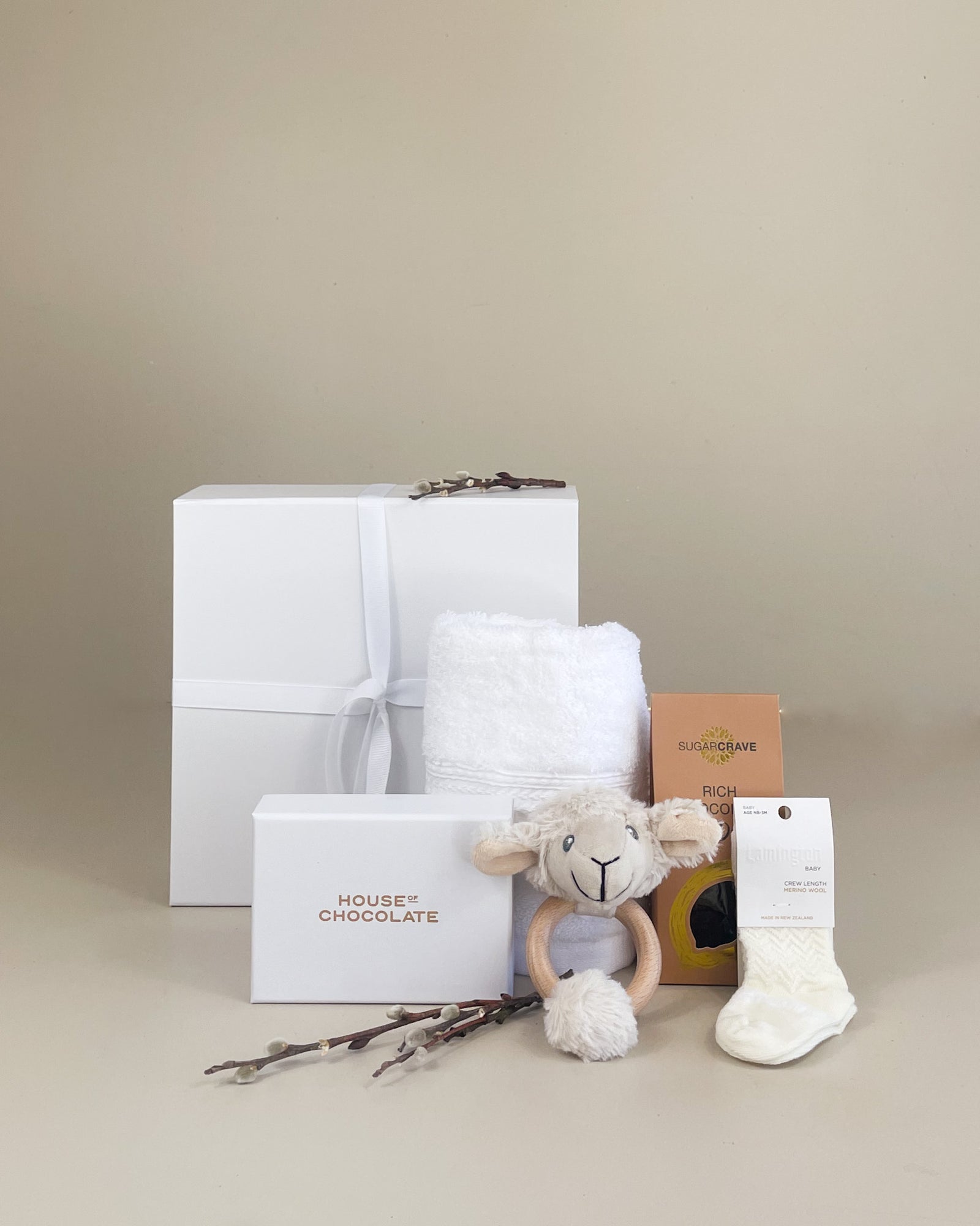 NZ newborn gift box with merino baby socks and wooden teether