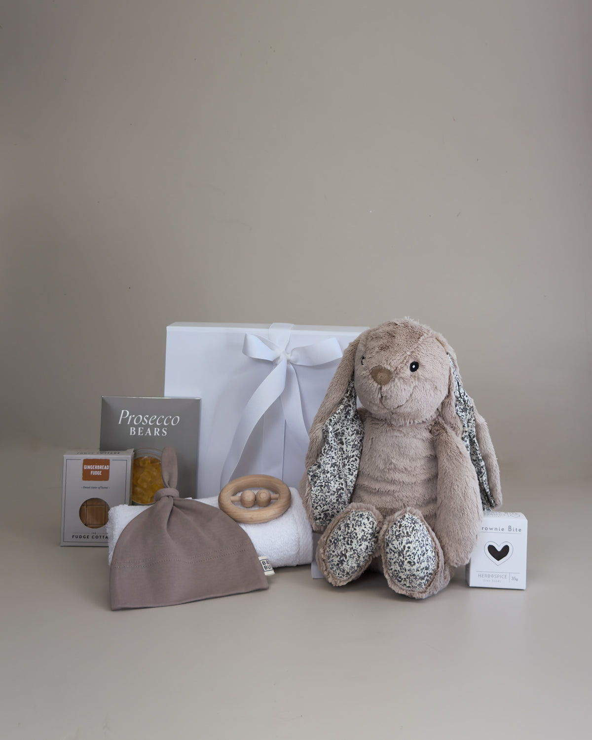 Deluxe baby boy newborn gift box with fluffy bunny, cotton beanie, teething toy and treats for new parents.