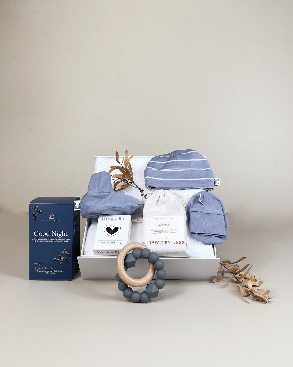 Luxury newborn baby boy gift box with merino beanie, booties, herbal tea and natural soap. Beautifully presented with NZ delivery.