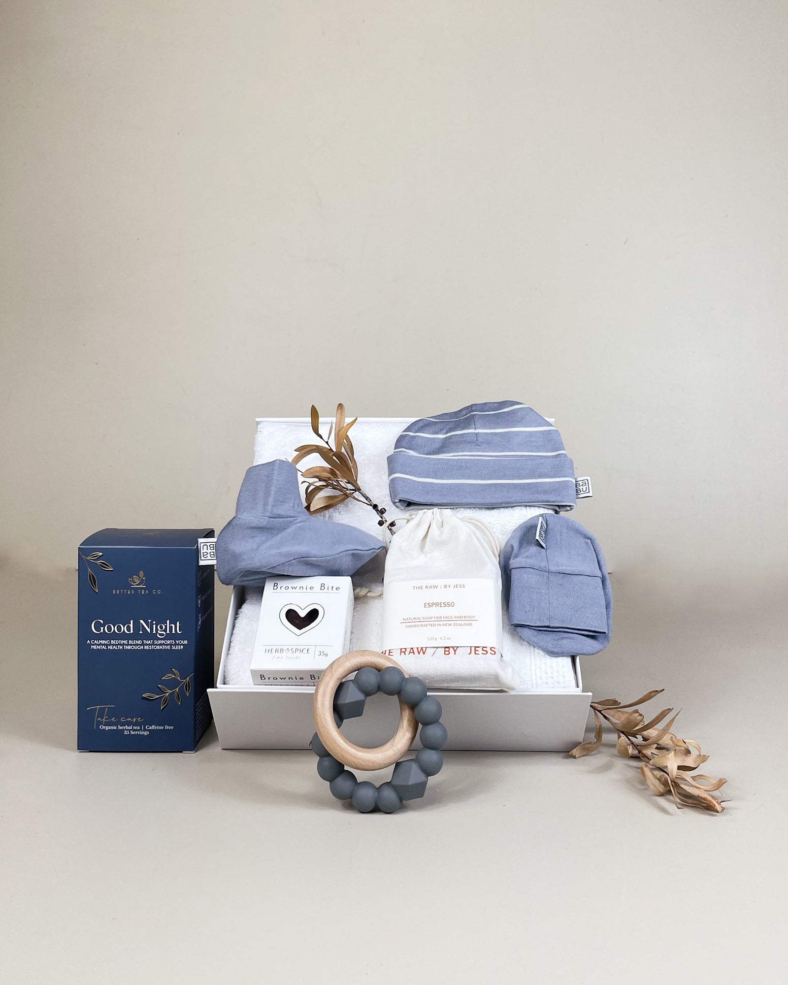 Luxury newborn baby boy gift box with merino beanie, booties, herbal tea and natural soap. Beautifully presented with NZ delivery.