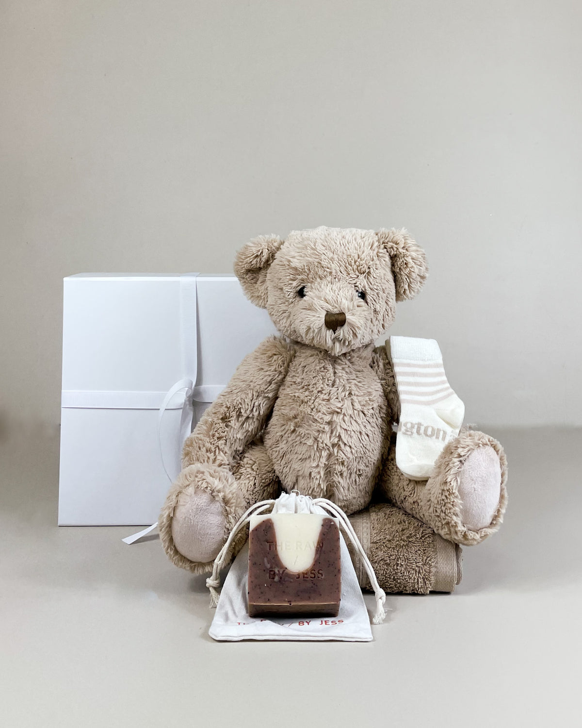 Luxury baby boy gift box featuring a fluffy keepsake teddy, merino baby socks, and natural organic soap for mum. Beautifully gift boxed NZ-wide delivery