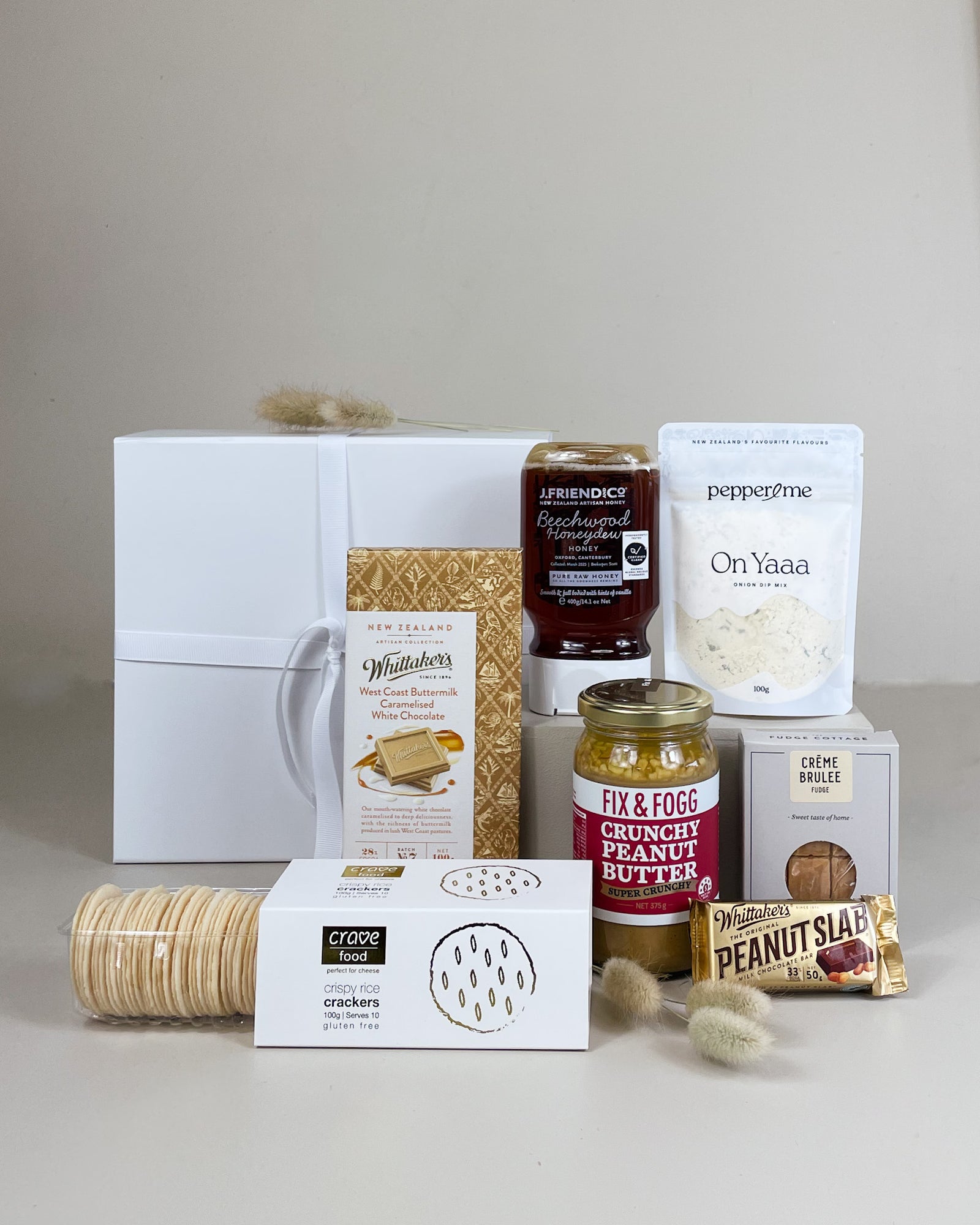 Kiwi Favourites Gift Box filled with New Zealand snacks including chocolate, peanut butter, onion dip mix, crisps, sweets, and gourmet treats.