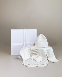 Newborn baby gift box with merino wool socks and long sleeve bodysuit, soft natural NZ-made baby hamper for warmth and comfort.