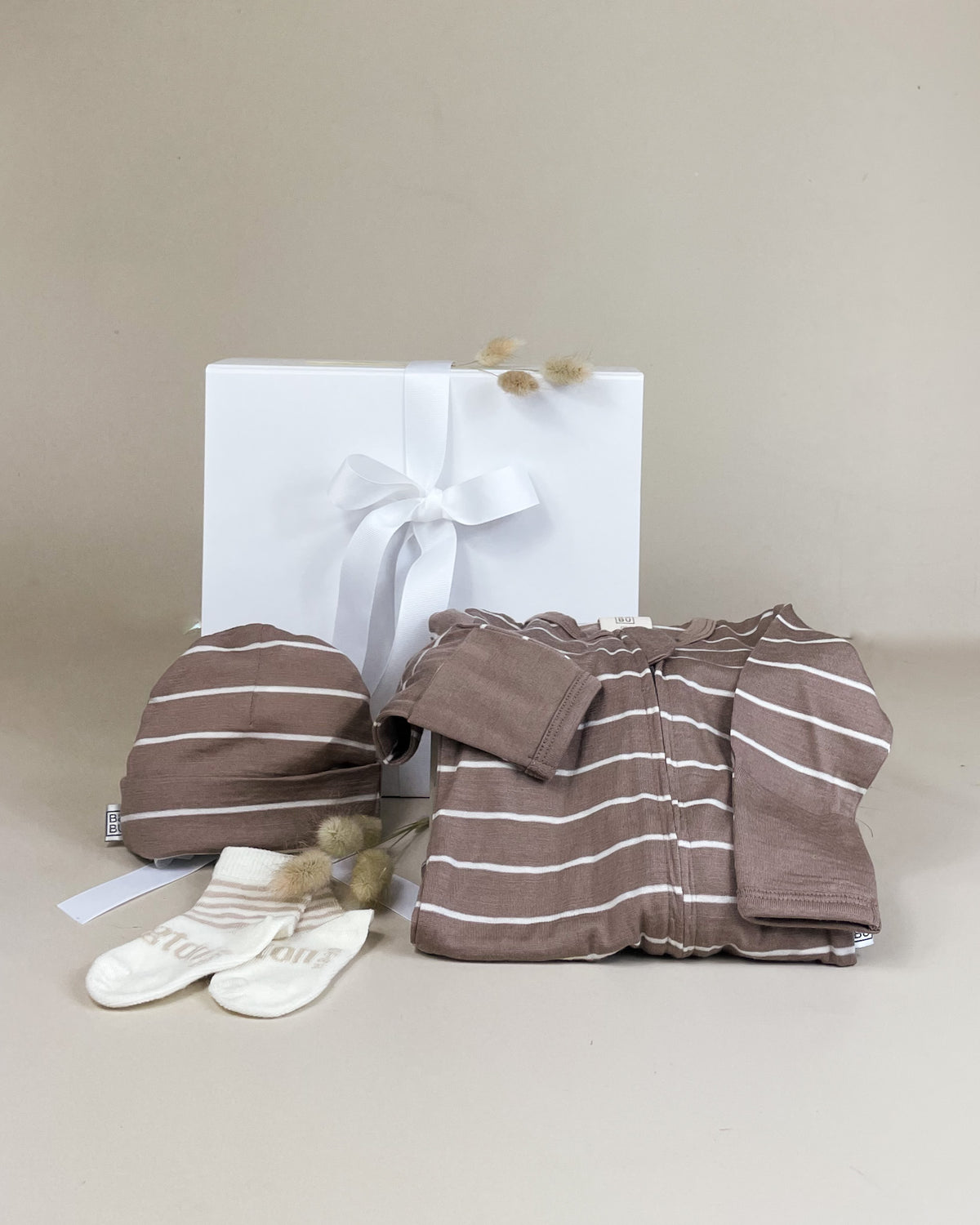 Luxury New Zealand merino baby gift box with merino beanie, footed bodysuit and newborn socks for a precious baby