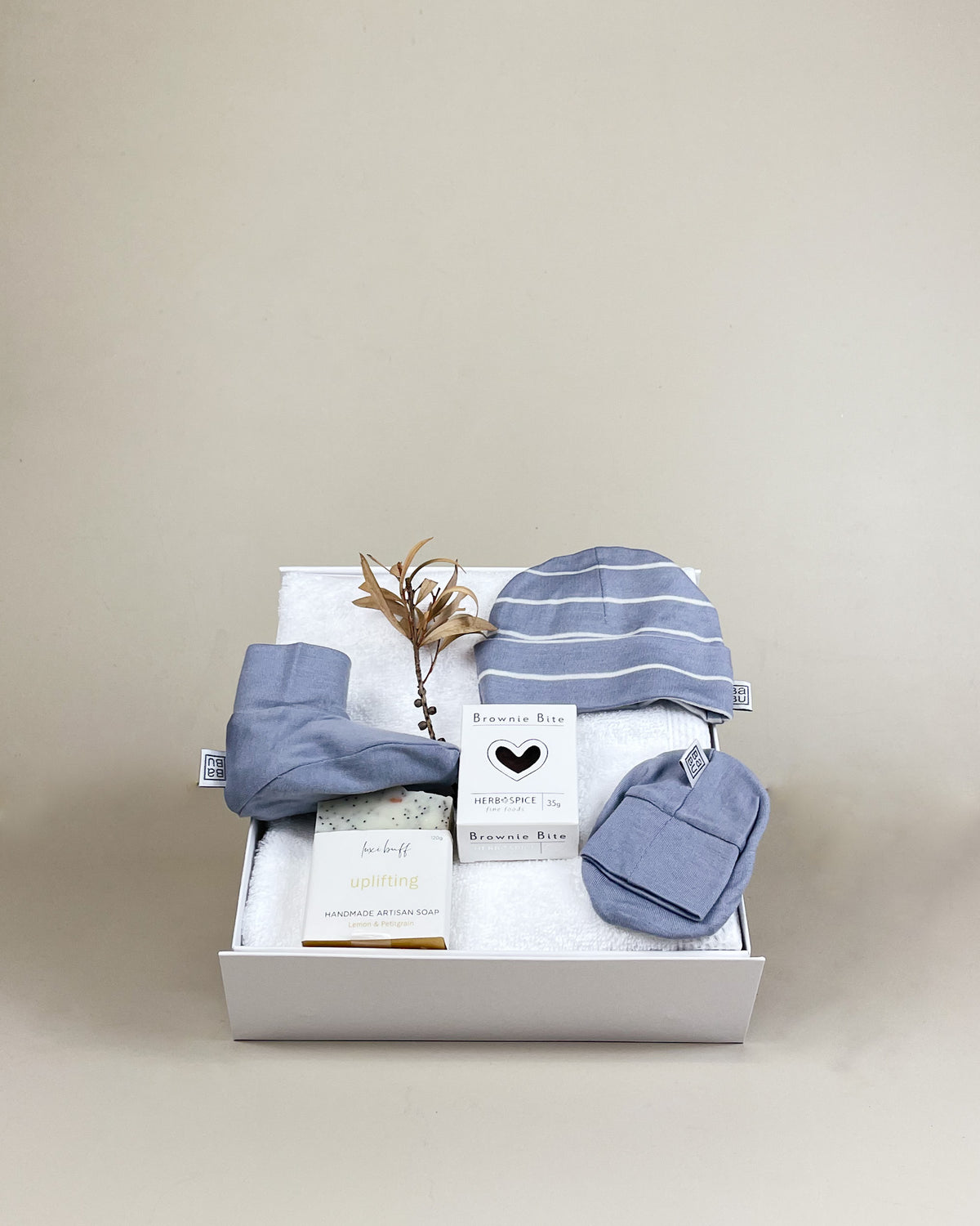 Luxury newborn baby boy gift box with merino beanie, booties, herbal tea and natural soap. Beautifully presented with NZ delivery.
