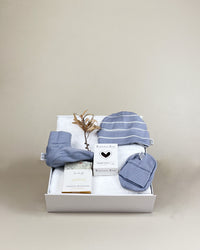 Luxury newborn baby boy gift box with merino beanie, booties, herbal tea and natural soap. Beautifully presented with NZ delivery.