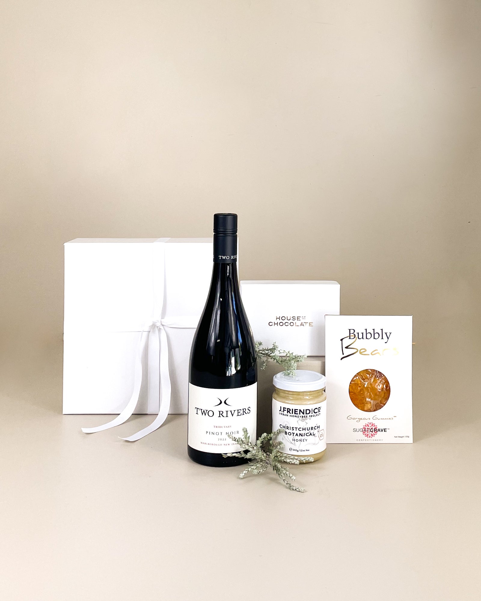 Luxury relaxation gift box with New Zealand wine, natural honey and handmade chocolates, beautifully presented as a self-care gift hamper.