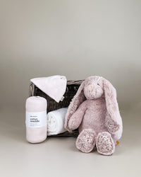 Sweet baby girl gift box featuring plush bunny, cotton swaddle, hand towel and keepsake basket, soft newborn gift hamper NZ.