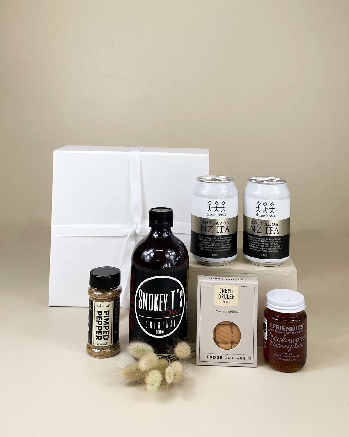 Taste of Canterbury Gift Box featuring Smokey T's BBQ Sauce, J Friend & Co Honey, The Fudge Cottage Fudge, Spice Craft Pimped Pepper seasoning and Three Boys IPA beer, beautifully presented in a premium gift box.
