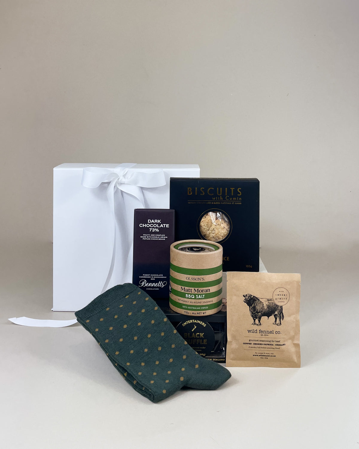 The Man Gift Box featuring artisan New Zealand lamingtons, Merino wool socks, BBQ salt, Wild Fennel Co. meat seasoning and gourmet savoury cookies in a luxury gift box.