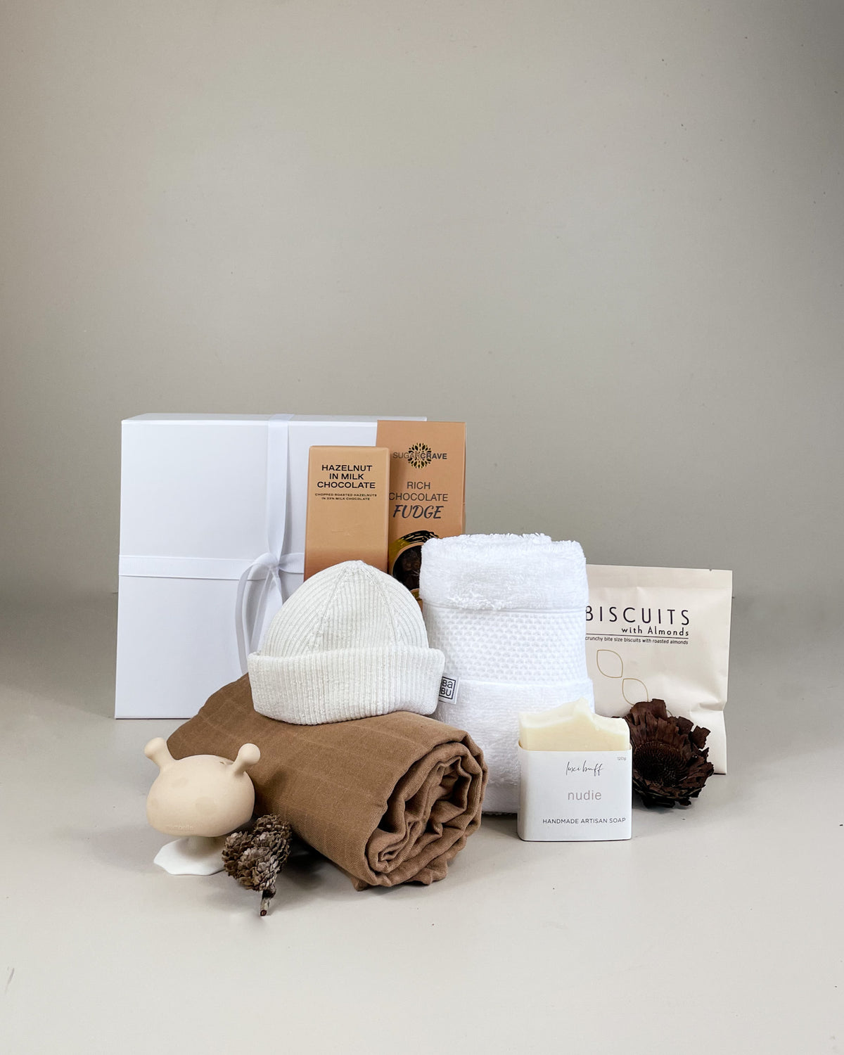 Welcome Little One gift box with baby socks, handmade chocolate, and artisan treats, perfect for celebrating a newborn in New Zealand.