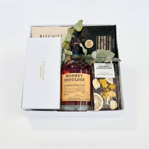 Whisky and artisan chocolate gift box featuring premium whisky and handcrafted chocolates.