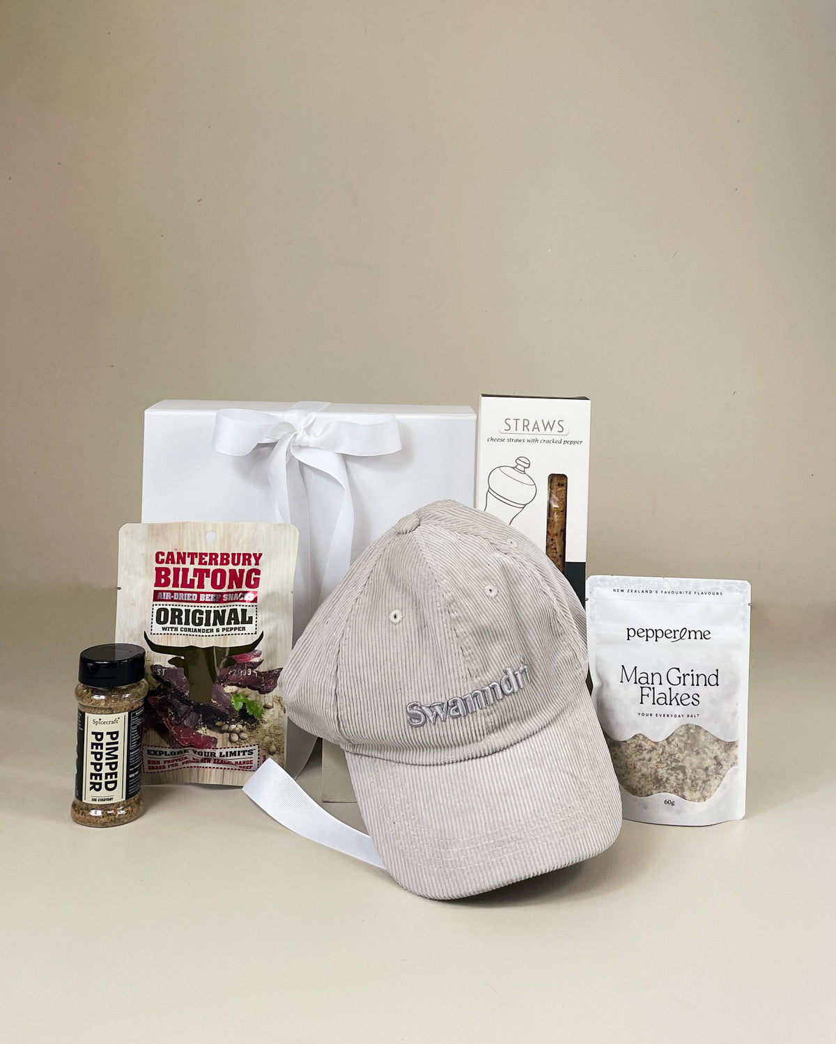 Outdoor Gift Box with Swanndri cap, Man Salt, New Zealand beef snacks and cheese sticks, presented as a premium gift for men.